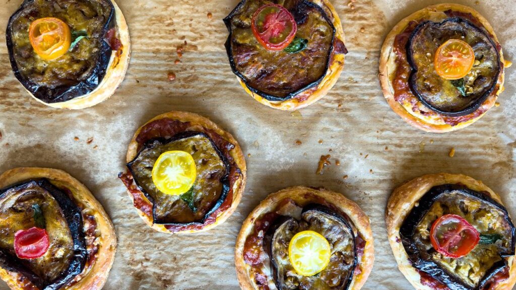 Eggplant parmesan rounds on parchment paper