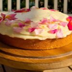 Frosted olive oil cake on cake stand